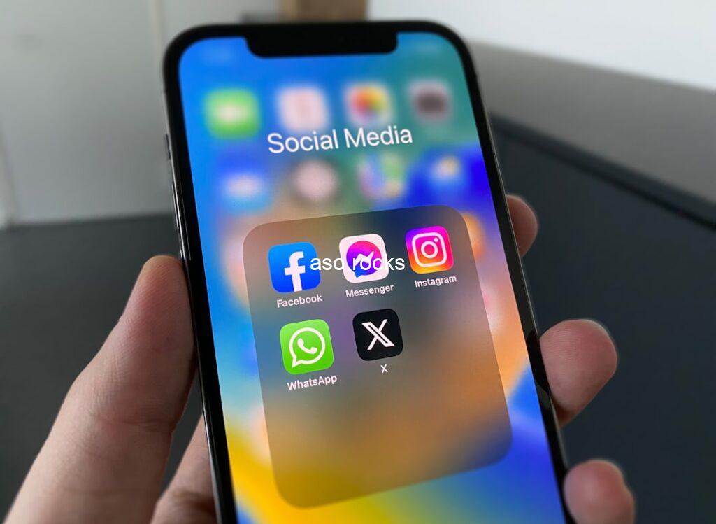 iPhone displaying Social Media app folder with Facebook, Messenger, Instagram, WhatsApp and X icons